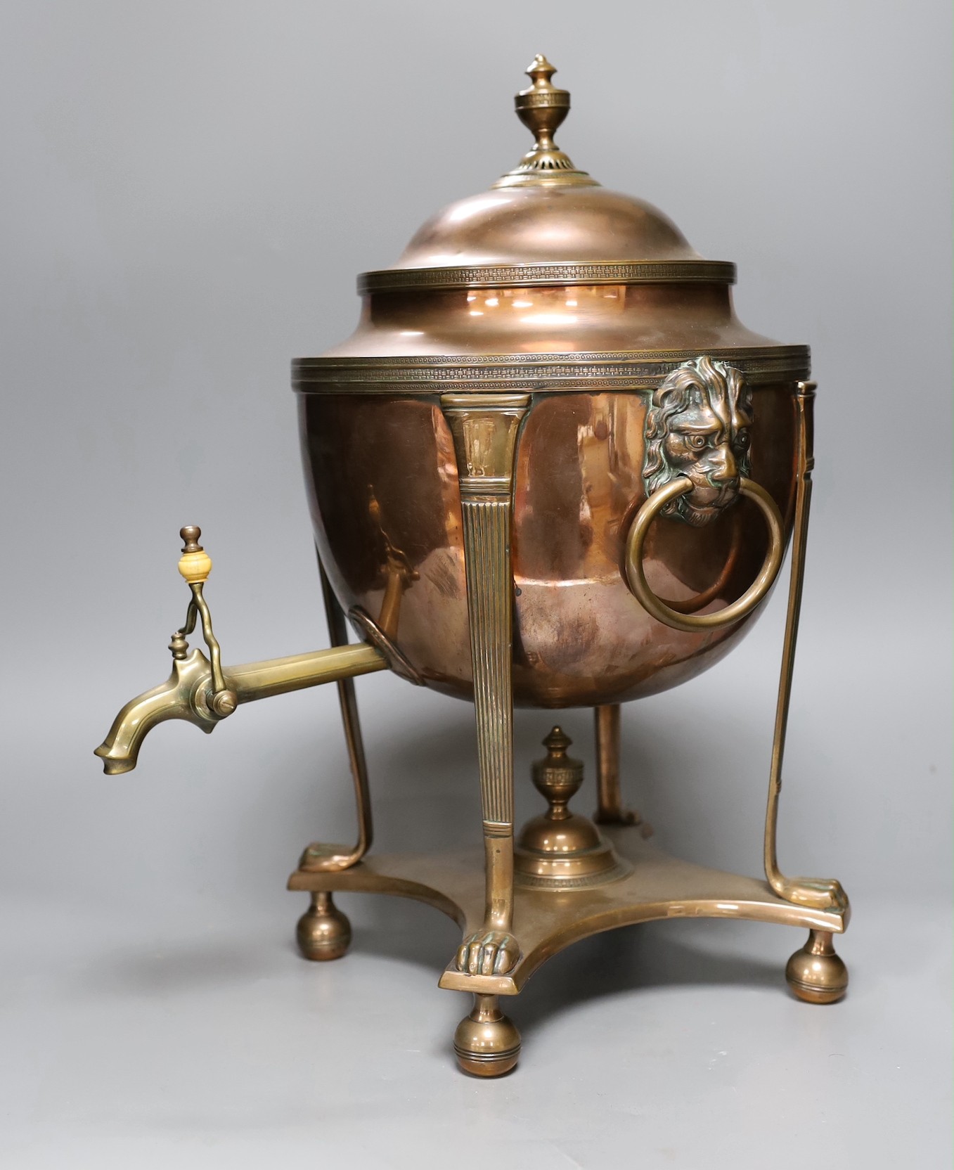 A copper samovar with lion mask handles, brass tap, 45cms high